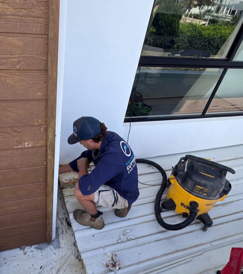 Roofer repairing fascia